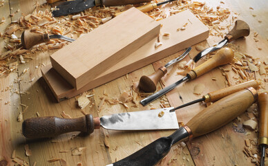 Canvas Print - Woodworker. Timber, wood processing. Joinery work. Wood carving with work tools close up. Hand of carver carving wood. Craftsman carving with a gouge