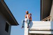 © NVB Stocker - Hispanic engineer man sitting and relax on the second floor of the house under construction.