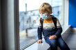 © Tomsickova - Cute  baby boy waiting boarding to flight in airport transit hall near departure gate. Active family lifestyle travel by air with children