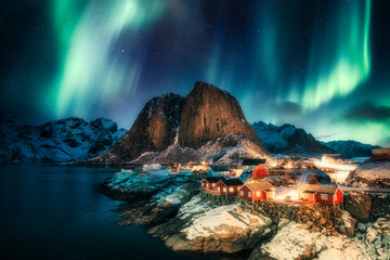 Wall Mural - aurora borealis, northern lights over mountain with fishing village on coastline at hamnoy, lofoten 