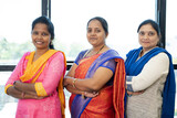 Fototapeta Londyn - Confidently standing Indian woman at office with crossed arms looking at camera - concept of leadership