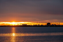 Sun Setting Over The Sea With Langstone Bridge And The Spinnaker Tower In The Background