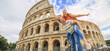 Happy couple - woman and man tourist have fun on vacation at Rome Colosseum