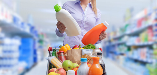 Woman comparing products at the supermarket