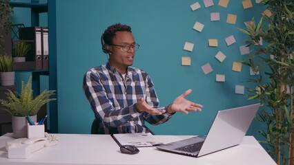 Wall Mural - call center operator having argument with client on helpline using headset with microphone and lapto