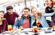 © Mirko Vitali - Trendy people on genuine fun moment at fancy pub restaurant - Life style concept with fashionable friends sharing happy hour time together at sidewalk cafe - Vivid filter with focus on central guy