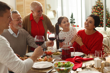 Wall Mural - Happy family enjoying festive dinner at home. Christmas celebration