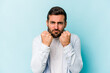 © Asier - Young caucasian man isolated on blue background showing fist to camera, aggressive facial expression.