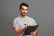 © SHOTPRIME STUDIO - man in gray t-shirt paper folder posing fun cropped view