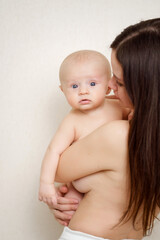 Canvas Print - beautiful and gentle naked mom and baby against the wall