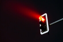 glowing red traffic light in foggy night