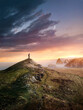 © James Thew - A man hiking to reach the top of a mountain summit at sunset along the UK coastline. Photo composite.