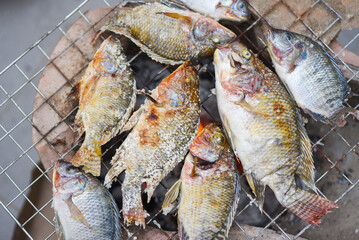 Wall Mural - grilled fish on the grill, Tilapia fish grilled with salt cooking fish burn Thai food