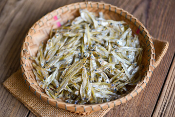 Wall Mural - small dried fish on basket and the sack background