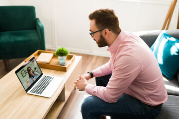 Wall Mural - Young man speaking with a virtual doctor