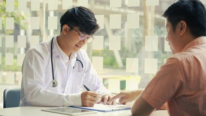 Wall Mural - Asian doctor is examining the abnormal items of the body and diagnosing the disease in the paper with the medical report of the patient.