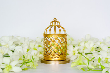 Wall Mural - Golden lantern with white orchid flower for the Muslim feast of the holy month of Ramadan Kareem.