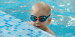 © ninelutsk - Toddler child learning to dive in indoor swimming pool with teacher. Standing on side, balancing and general physical activity for kids in water, early development. Boy kid instructed