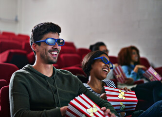 Sticker - Thrills and spills never looked this good. Shot of a man and woman laughing while watching a 3D movie at the cinema.