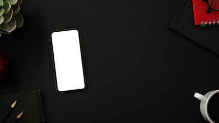 Black background with smartphone, copy space and accessories.