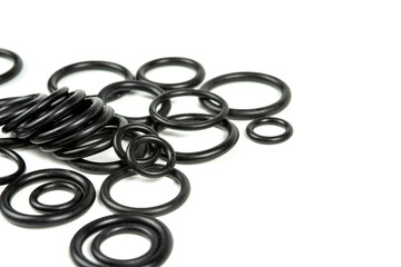 Hydraulic and pneumatic o-rings in black in different sizes on a white background. Various seals for plumbing. Sealing rings for hydraulic connections.