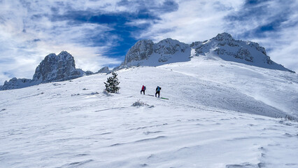 Wall Mural - winter hiking team approaching the summit