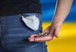 Man showing hands with money. Flag of Ukraine. Bankruptcy financial crisis and poverty concept. Close up