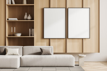 Bright living room interior with two empty white posters, sofa