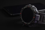 Fototapeta Psy - Black smart watch on the smartphone. Closeup, selective focus
