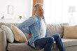 © Prostock-studio - Mature man with back pain sitting on couch at home