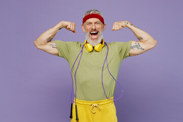 Wall Mural - Vivid elderly gray-haired bearded man 40s years old in headband khaki t-shirt skipping rope on neck show biceps muscles on hand scream isolated on plain pastel light purple background studio portrait.