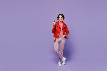 Poster - Full body young smiling satisfied happy woman 20s wear red leather jacket hold takeaway delivery craft paper brown cup coffee to go isolated on plain pastel light purple background studio portrait