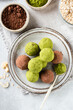 Sweet vegan truffles with green matcha tea powder, nuts, oats and dates. Top view. Healthy low calorie homemade sweets