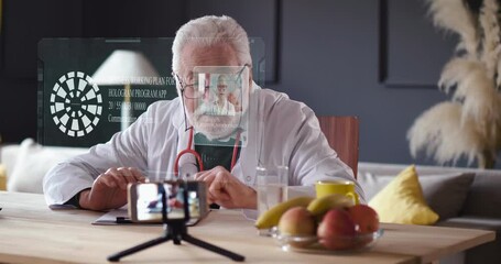 Elderly Doctor using virtual Hologram interactive technology for video meeting with colleague from home.