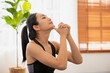 In sportswear, an Asian woman exercises In the fitness studio, practice neck stretching and meditation for better health.