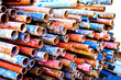 A heap of colored rusty pipes on the street