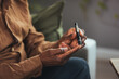 © Dragana Gordic - Senior man with glucometer checking blood sugar level at home. Elderly man testing for high blood sugar. Man holding device for measuring blood sugar