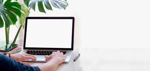 Laptop computer screen mockup, template background banner, Man hand typing on laptop computer with blank white screen, Business online, ecommerce, online learning concept.