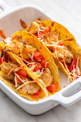 Wall Mural - tacos filled with grilled chicken meat and tomatoes