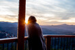 © Cowen - A young woman looks out over the mountains from her cabin