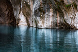 Fototapeta Dziecięca - clear blue water in a deep canyon with sheer rock walls