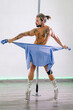 Pole dance man, young venezuelan doing striptease in the pole dance studio