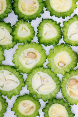 Wall Mural - slices of bitter melon isolated on white background. top view