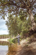 © alexey351 - Fisherman on the bank of a beautiful river.