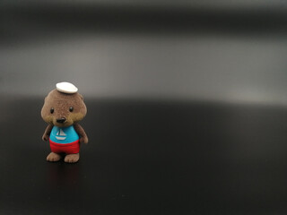 Wall Mural - Small toy isolated on a black background