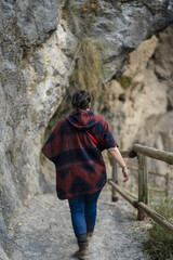 Sticker - Rear view of a Caucasian female traveler walking on the rocky route of Sierra Nevada in Granada