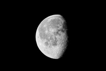 Poster - Closeup shot of waxing gibbous moon isolated on black background