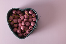 Pink Wooden Beads In Heart Backing Form Isolated On Pink Background