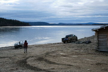 Poster - Small hut and a dirty pickup truck parked on the Yukon river's bank