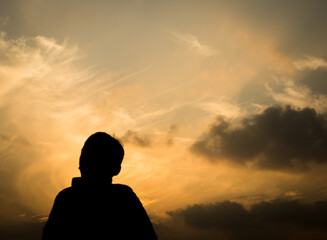 Poster - Silhouette of a boy in-front of evening sky.